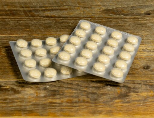 Cartelas de medicamento sobre uma mesa.